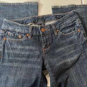 Seven brand flare leg jeans with slight distressed look in the pockets.